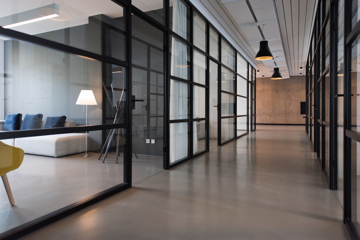 An open, sunlit workspace with shared tables and room to collaborate